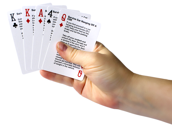 Hand with playing cards that are used for a survival game.