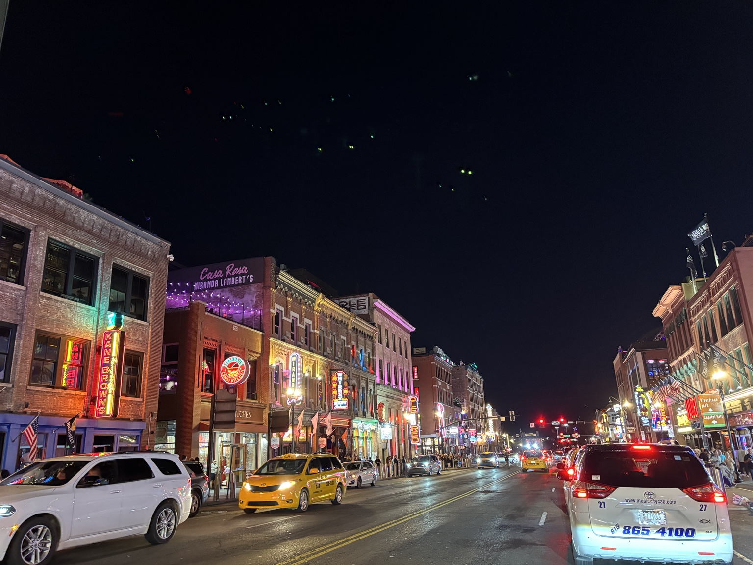 Nashville street with illuminated storefronts at night
