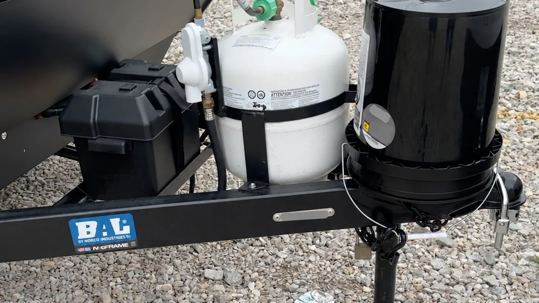 Black steel travel trailer A-frame Black painted steel A-frame of a travel trailer with tongue jack, battery box, and propane cylinder.